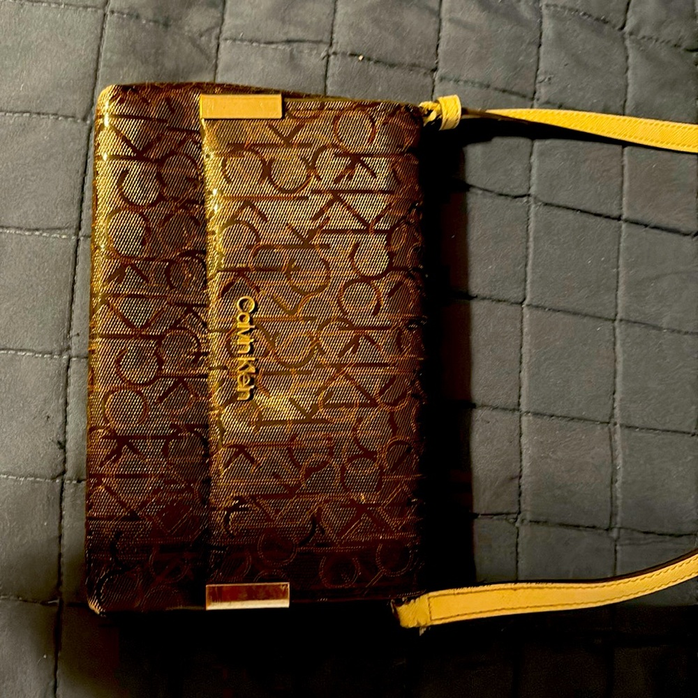 Brown Calvin Klein Crossbody with a cream colored strap